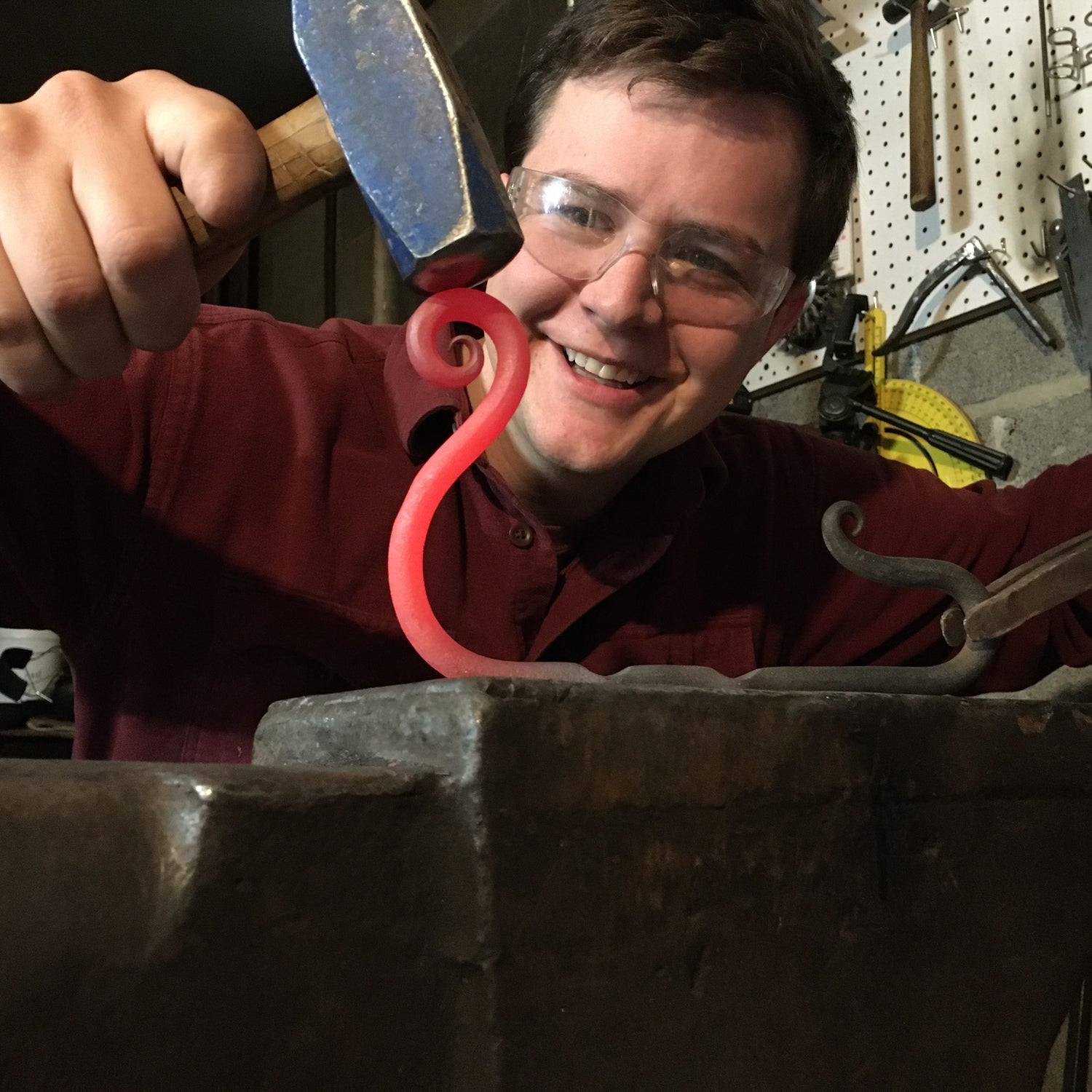 Hogan carefully forms a scroll